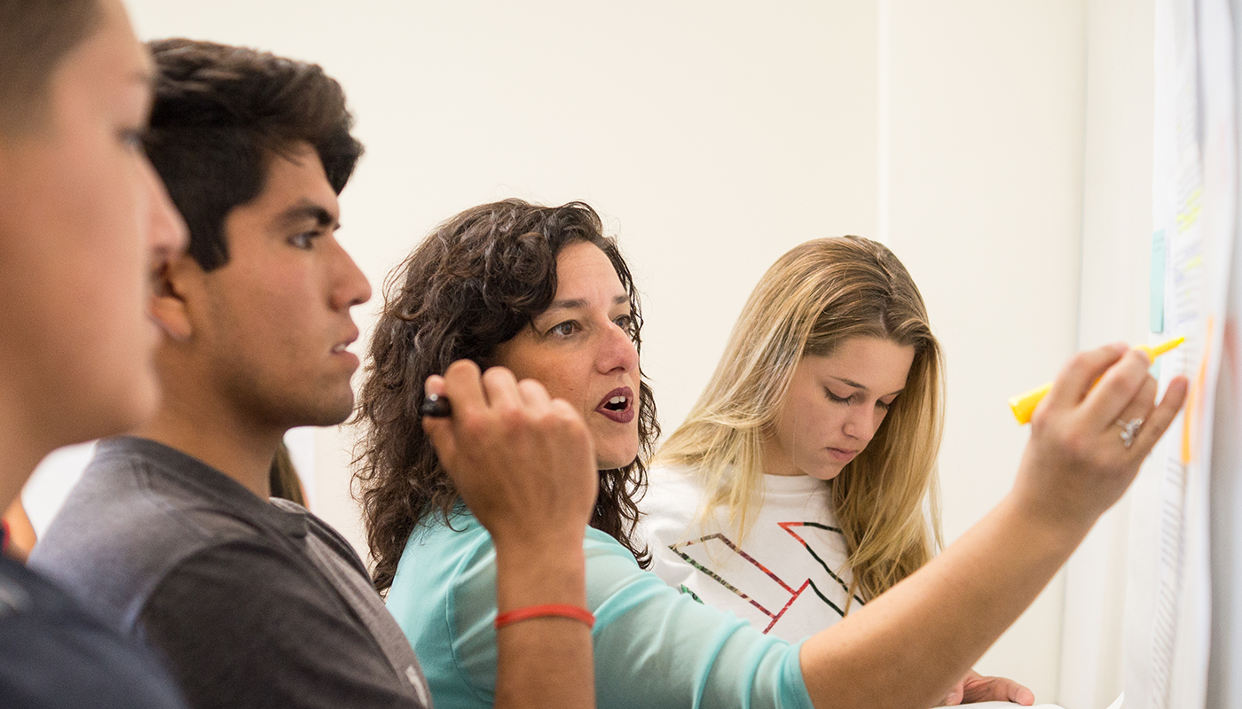 SBCC English Teacher showing students writing techniques.